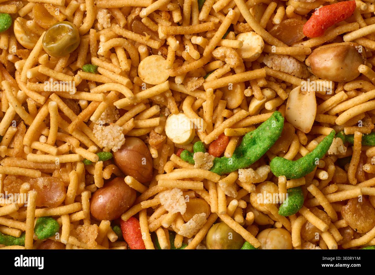 indian savory snack mixture full frame texture, fried chickpea flour noodles with peanuts and peas, top view macro, culinary and traditional appetizer Stock Photo