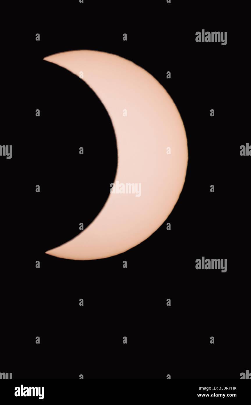 Partial solar eclipse in the dark. Actual image taken through a solar filter. Stock Photo