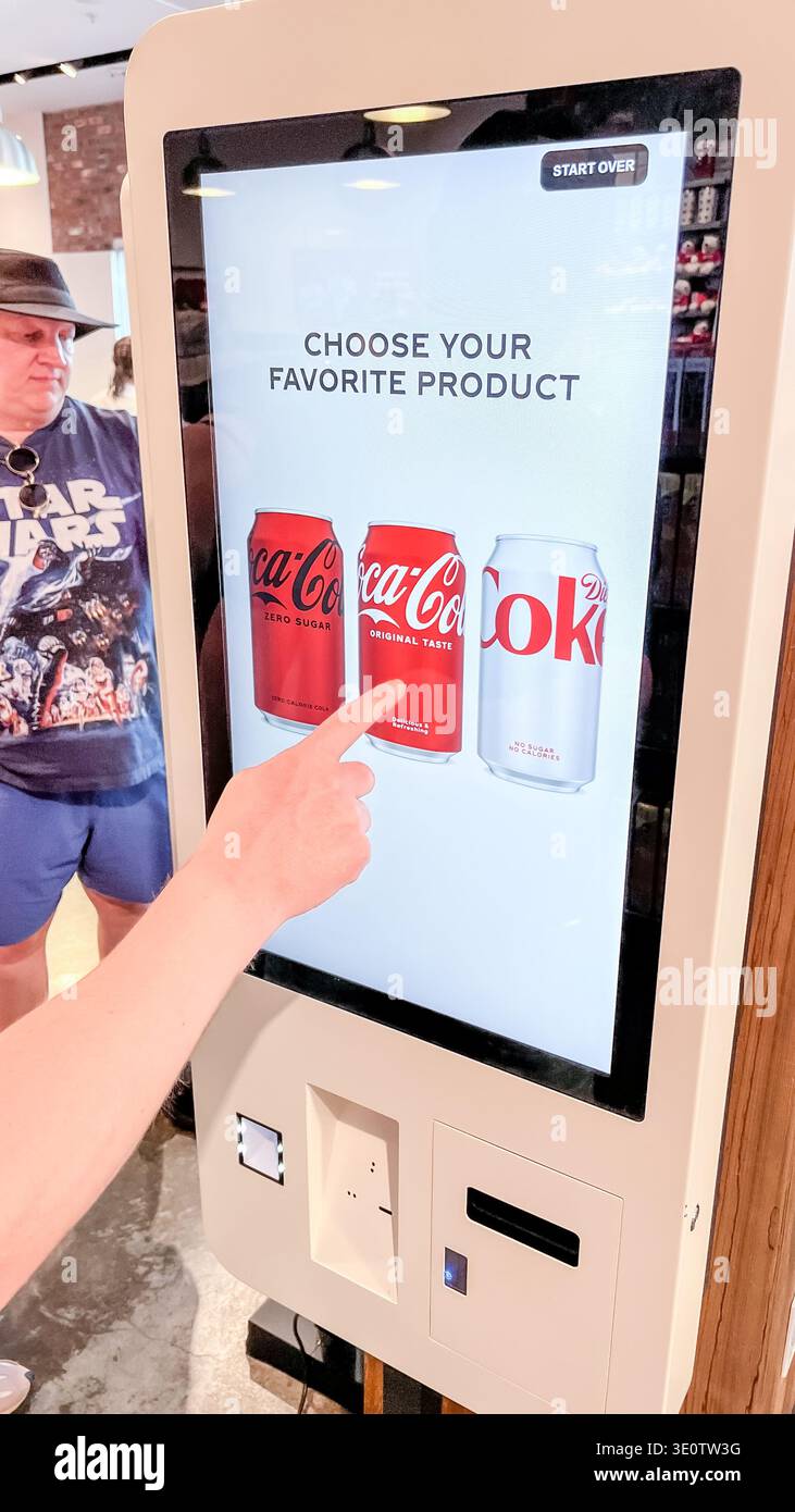 Orlando FL, USA - March 06, 2026: Coca-Cola vending machine features a ...