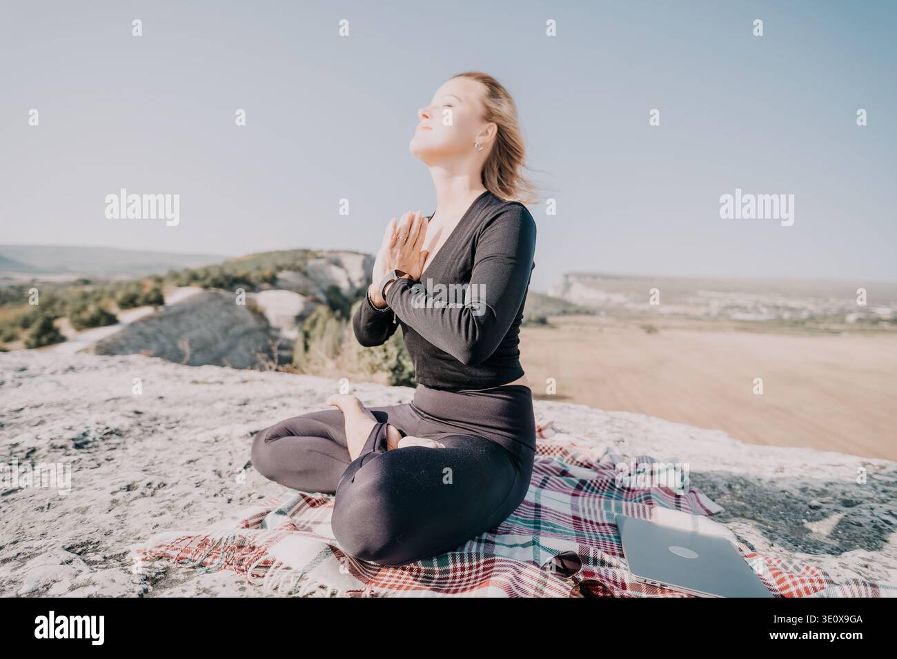 Woman Meditating on a Mountaintop Stock Photo