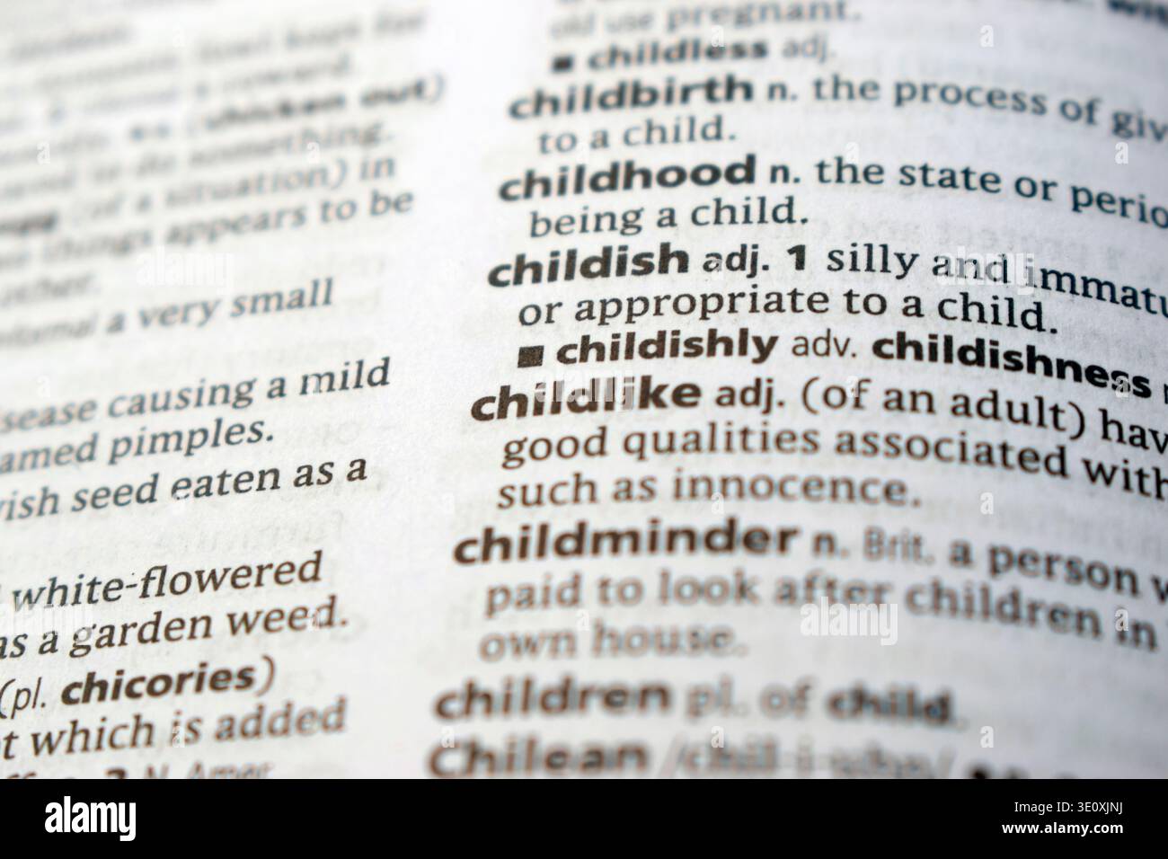 Detail Of English Dictionary Page And Word Pronunciation Of - childlike Stock Photo