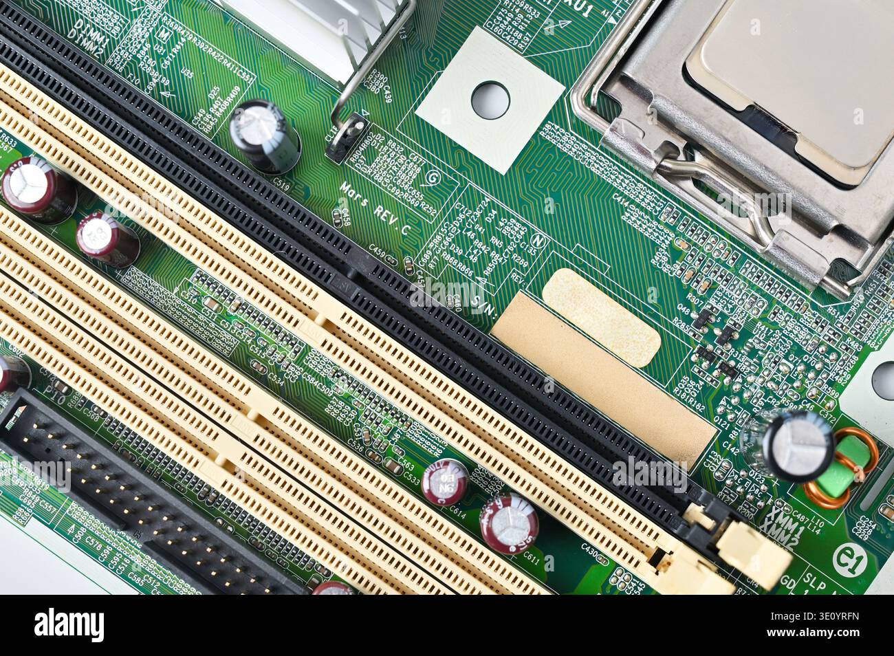 Close-up view of a computer motherboard with RAM slots and CPU socket ...
