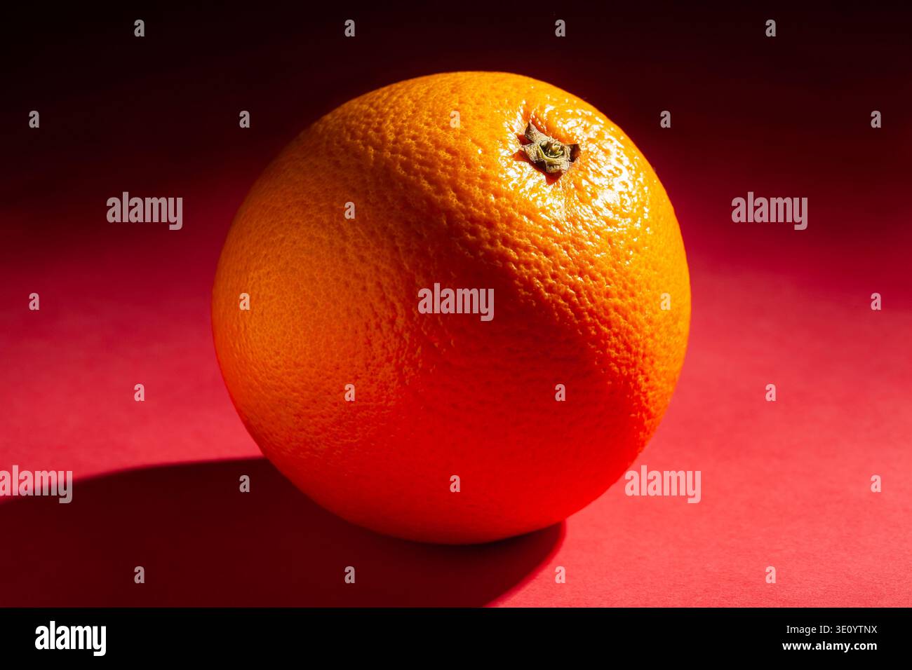 orange fruit on red background Stock Photo