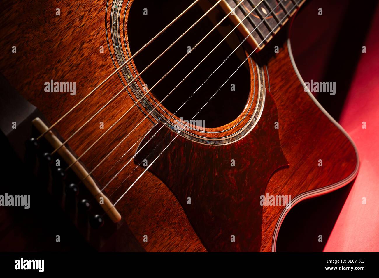acoustic guitar on red background Stock Photo