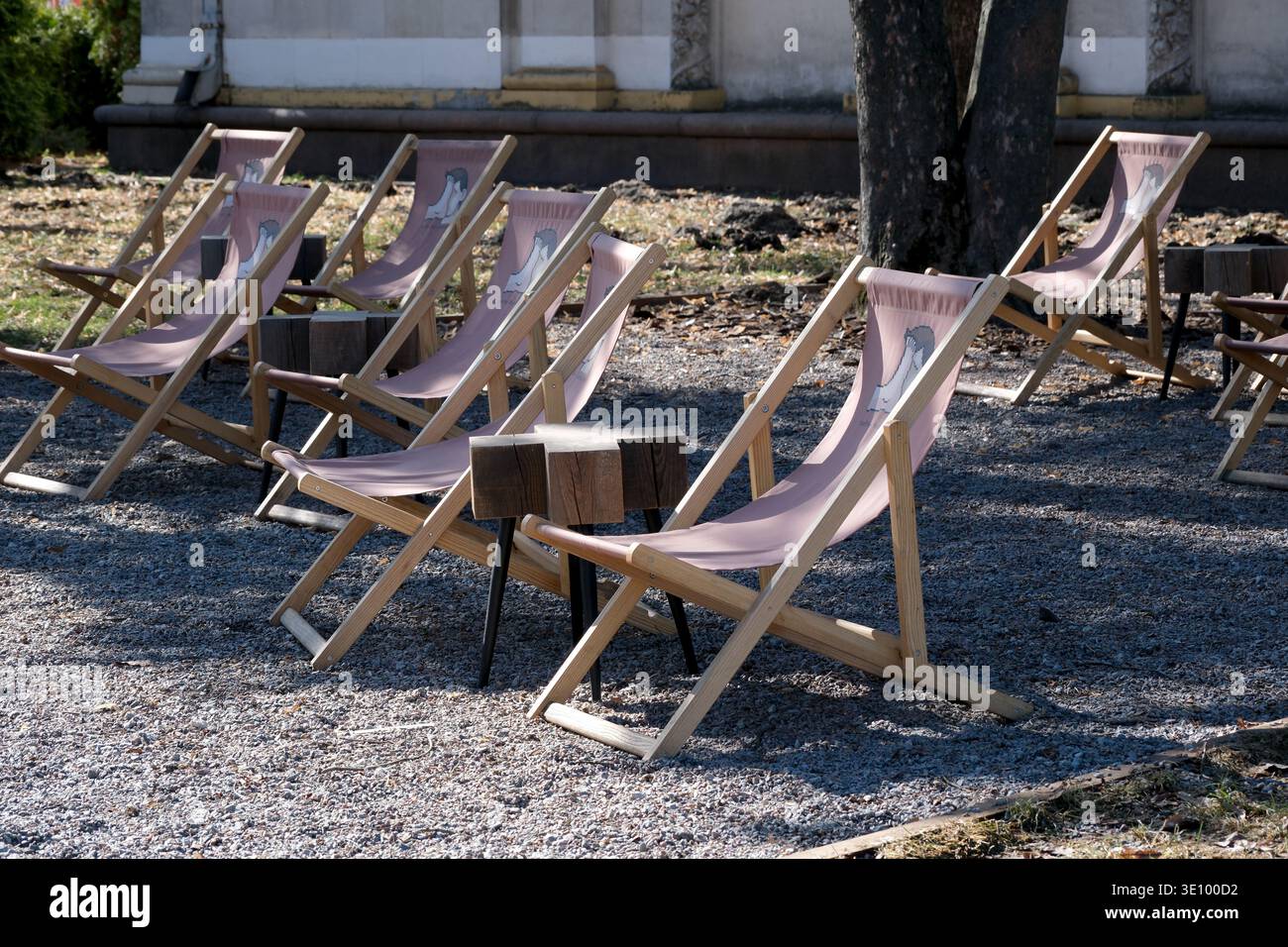 Cozy wooden chairs invite visitors to enjoy the peaceful afternoon sun. Stock Photo