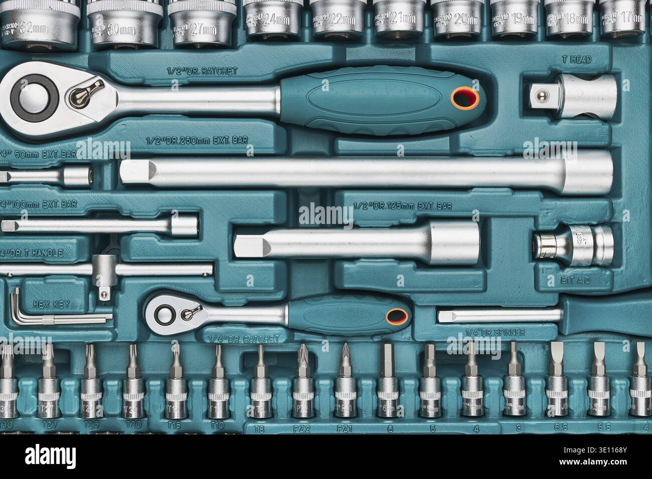 Ratchet with many attachments in plastic case. Work tools. Universal tool set. Background Stock Photo