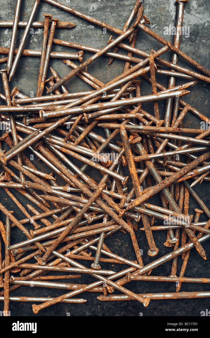 Rusty nails on steel surface. Tools for maintenance. Hardware tools to fix. Technical background with copy space Stock Photo