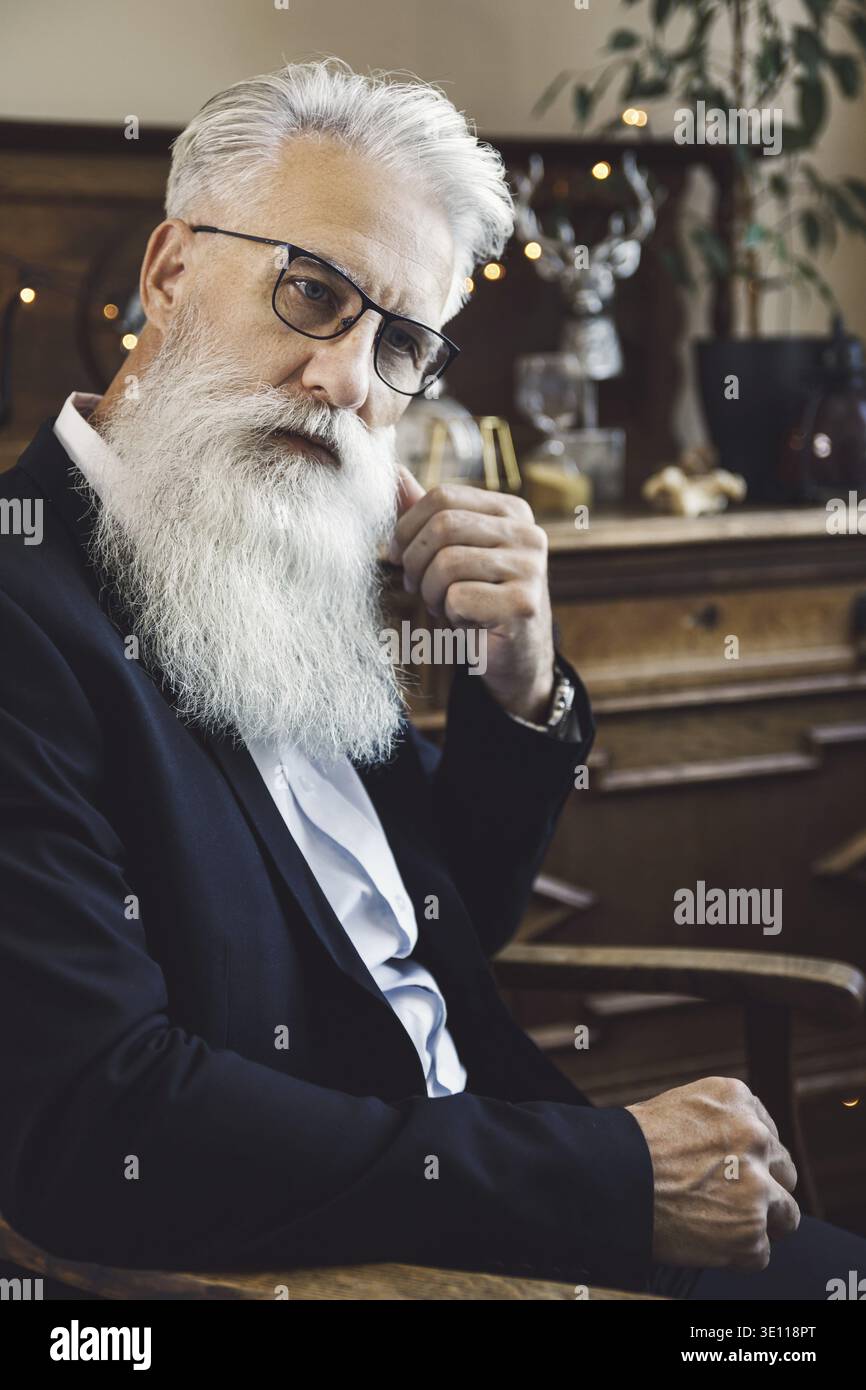 Stylish and handsome bearded senior man posing in studio Stock Photo