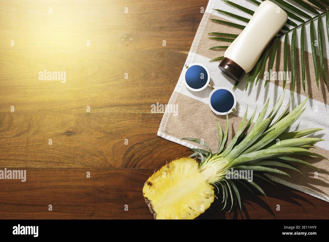 Different items for beach vacations. Sunscreen, sunglasses and pineapple fruit Stock Photo