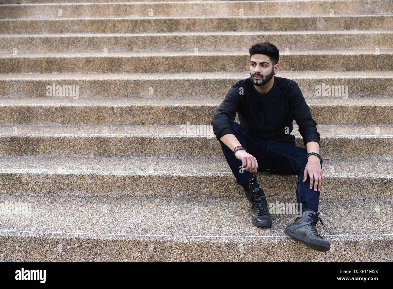 Young handsome Indian man sitting at stairs Stock Photo - Alamy