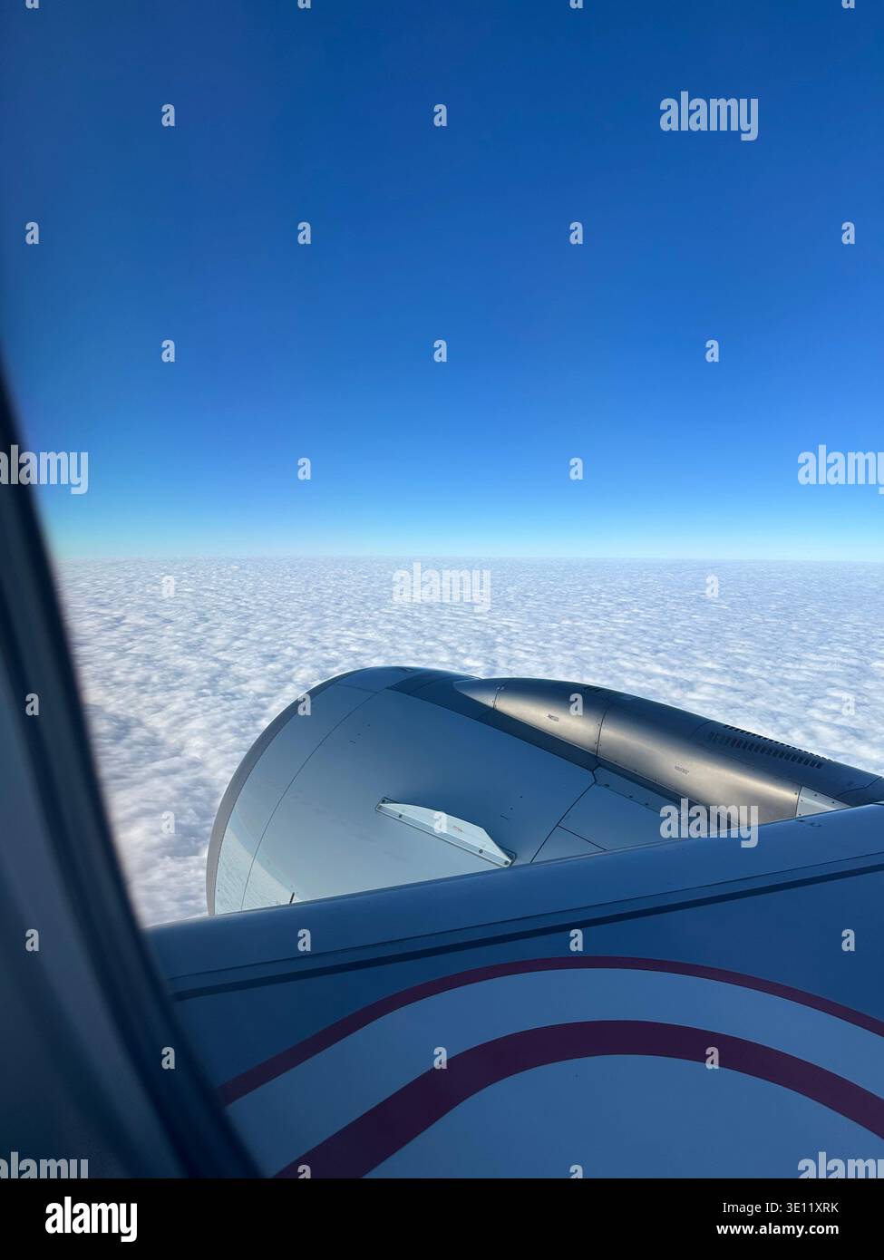 Dramatic and fluffy cloudscape with the airplane from the airplane's window Stock Photo
