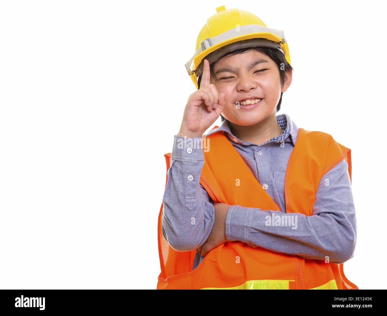 Happy Japanese boy construction worker smiling while pointing finger up Stock Photo