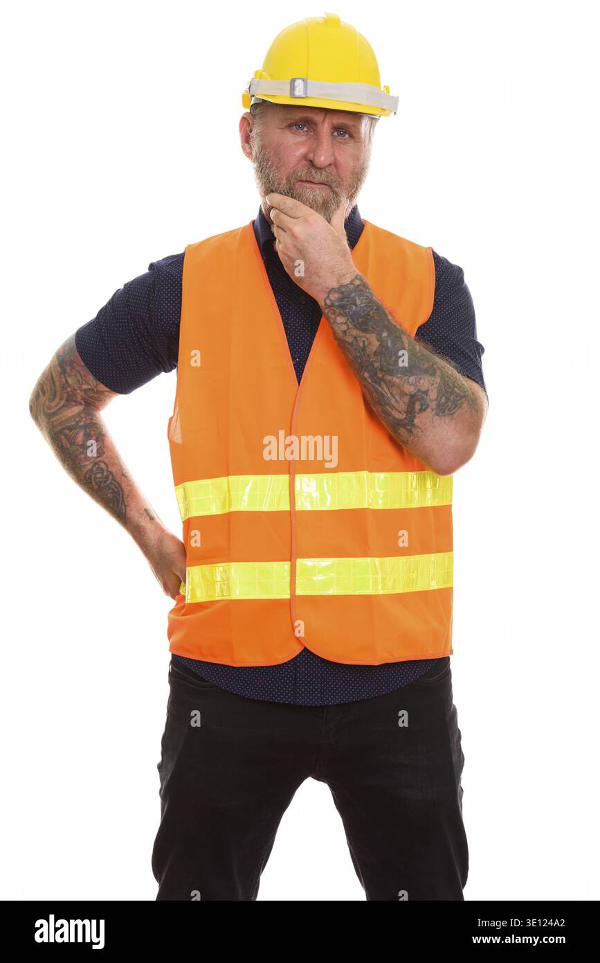 Mature bearded man construction worker with hand tattoos thinking Stock Photo