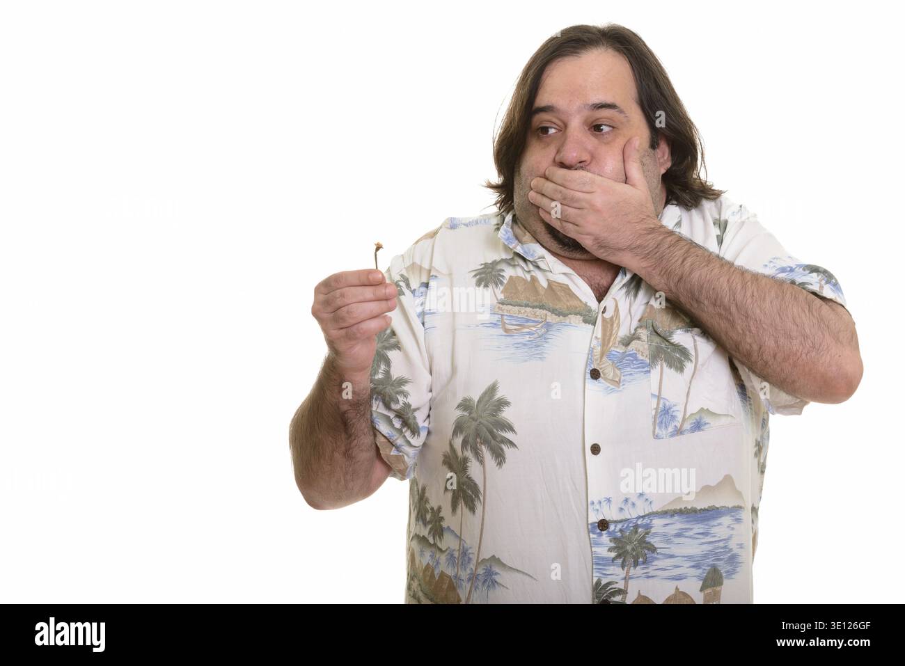 Fat Caucasian man eating spicy chili pepper looking nauseous isolated against white background Stock Photo