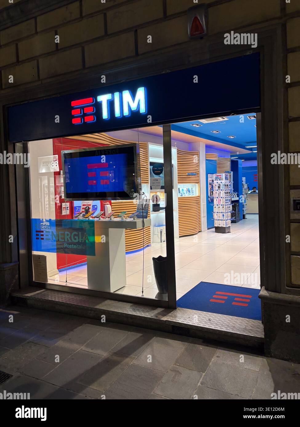 TIM Telecom Italia store exterior. Brightly lit electronics retailer in Pisa, Tuscany, Italy, showing modern branding. Stock Photo
