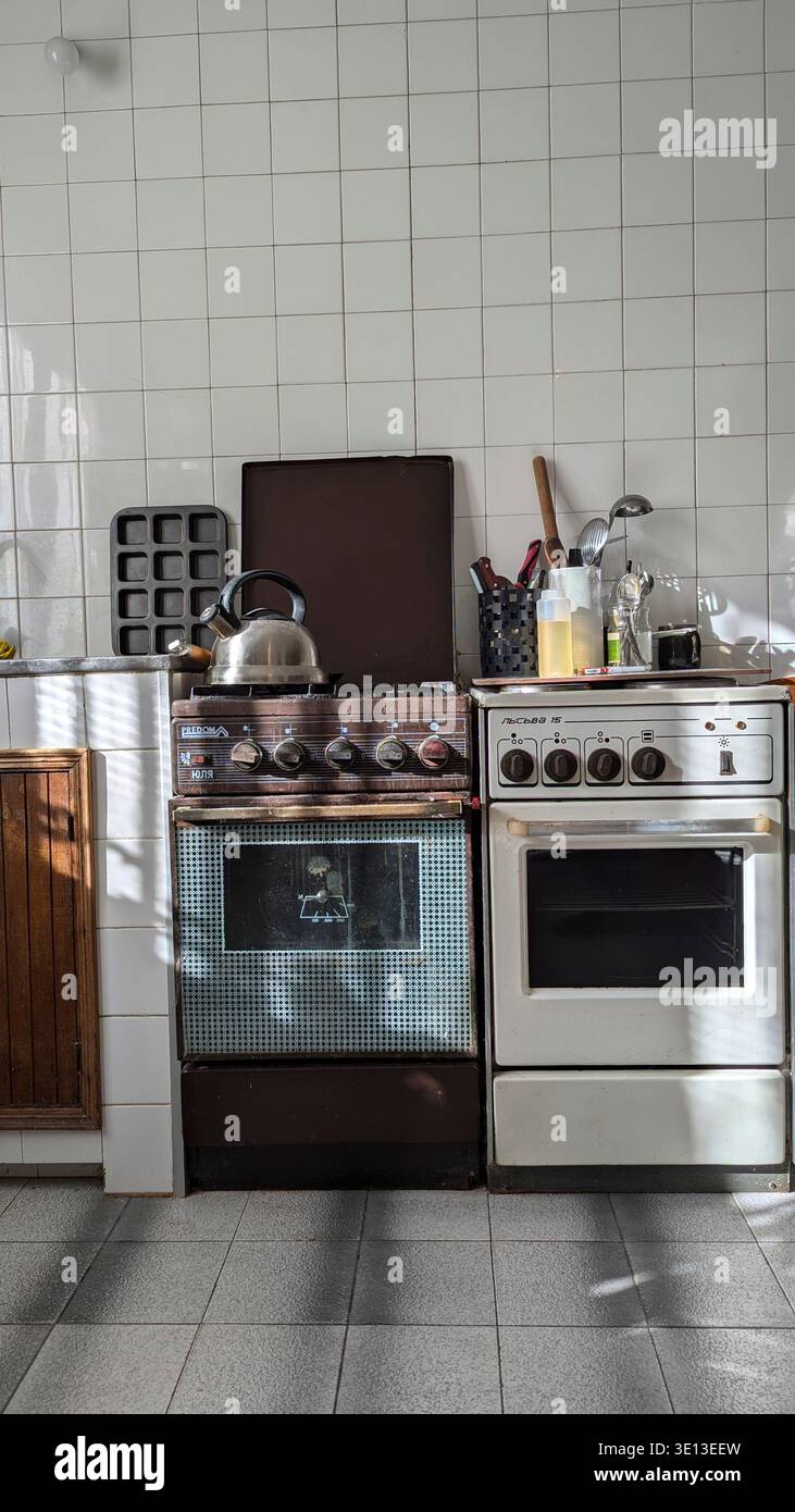 Old kitchen interior. stove. Shabby floor, tiles. Stock Photo