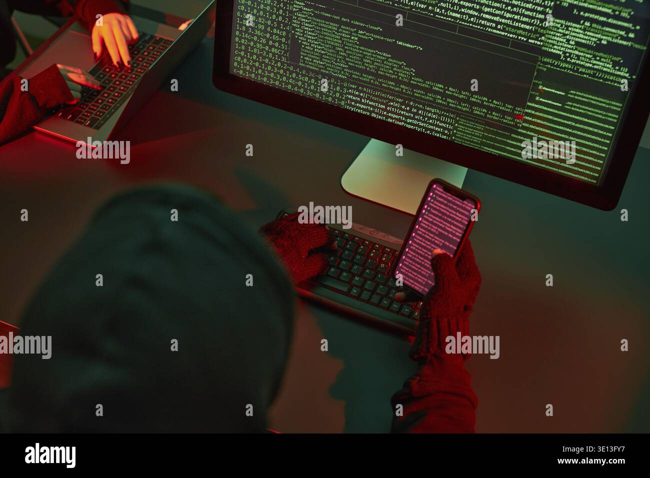 Anonymous people using computer and programming to break code. Cyber security threat. Internet and network security. Access to private information. An Stock Photo