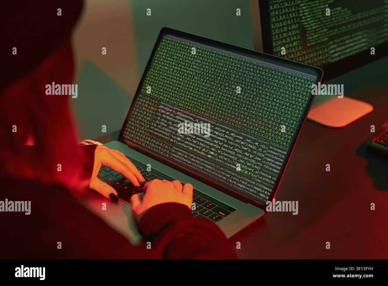 Anonymous people using computer and programming to break code. Cyber security threat. Internet and network security. Access to private information. An Stock Photo
