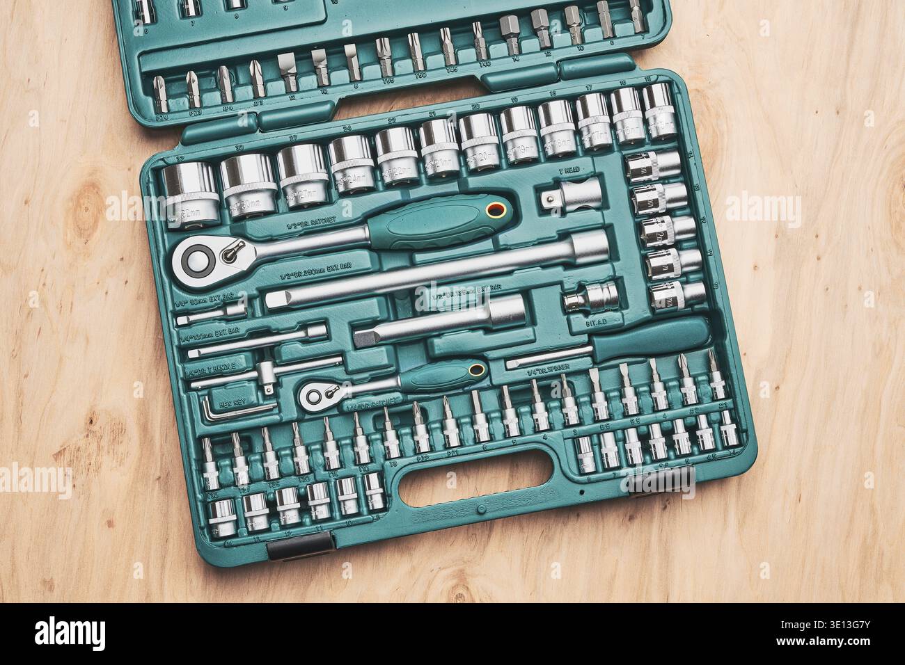 Ratchet with many attachments in plastic case. Work tools. Universal tool set. Background Stock Photo