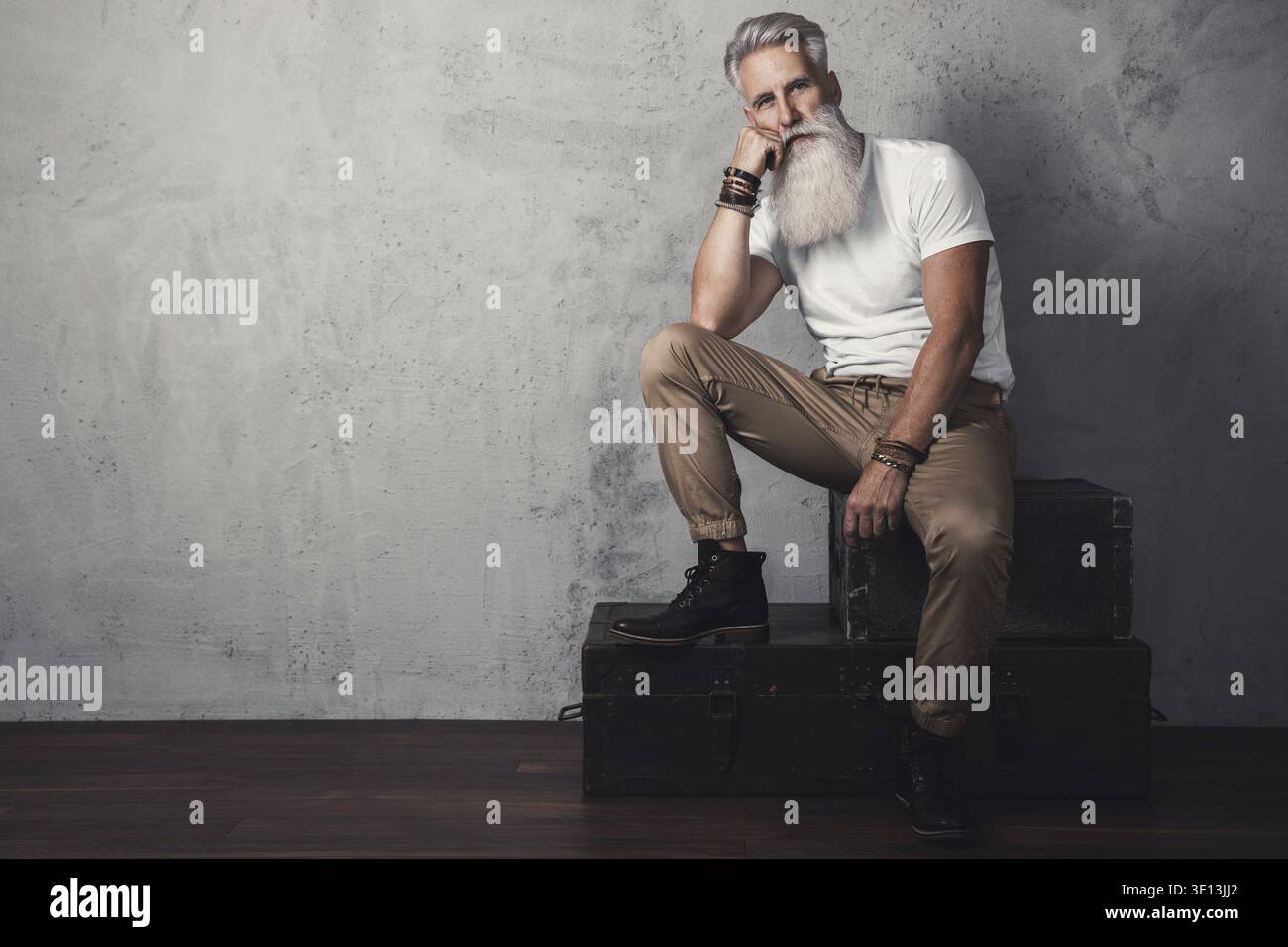 Stylish and handsome bearded senior man posing in studio Stock Photo