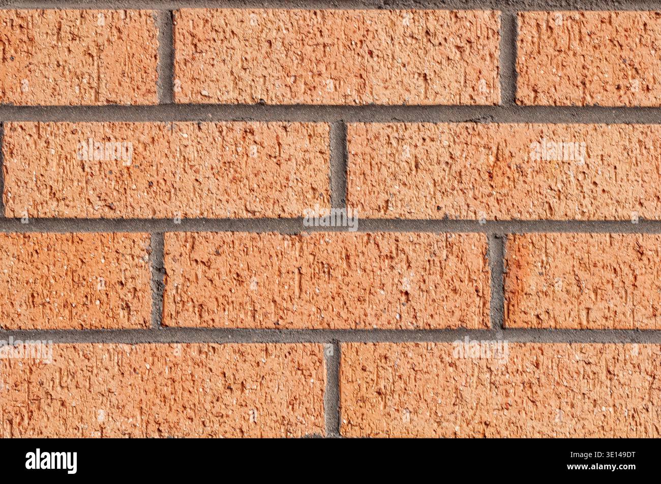 Clean orange brick wall texture with uniform pattern and visible mortar lines Stock Photo