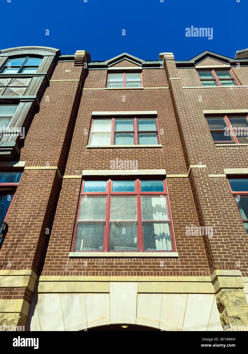 Multiple Window Building The view shows multiple windows on a brick building. The sky is clear ...