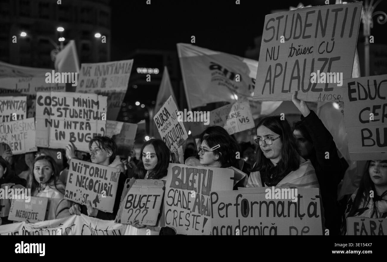 Romanian students protesting in Victoria Square, Bucharest, organized by ANOSR on March 14, 2026. The images show students holding banners and signs. Stock Photo
