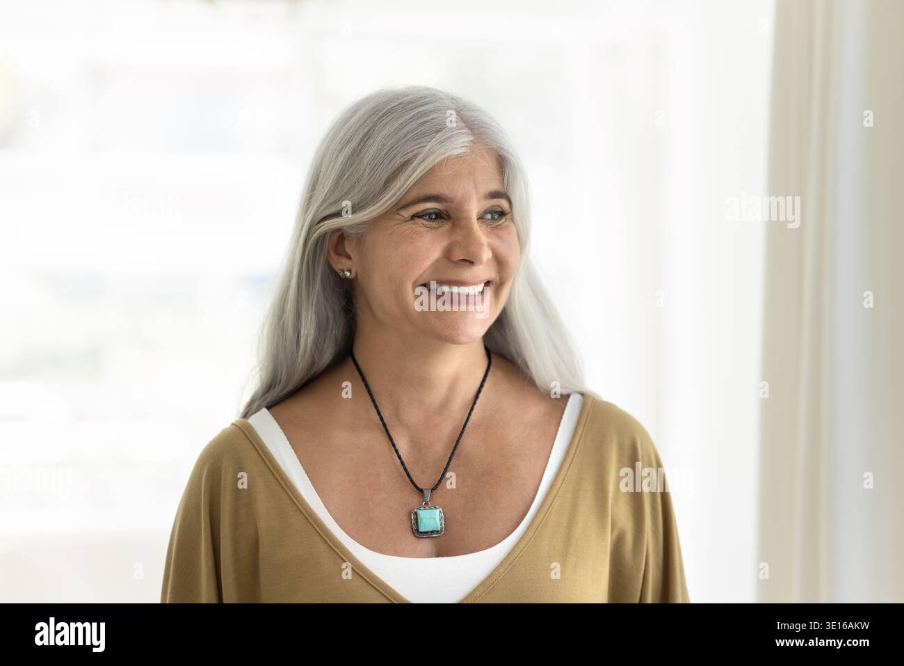 Middle-aged woman looking with smile into distance Stock Photo