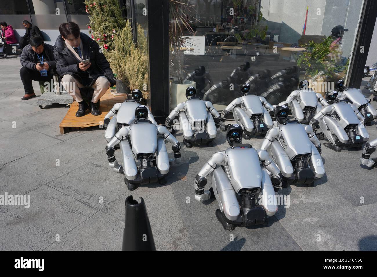 Humanoid robots wait for a promotion event in Beijing, Sunday, March 15 ...