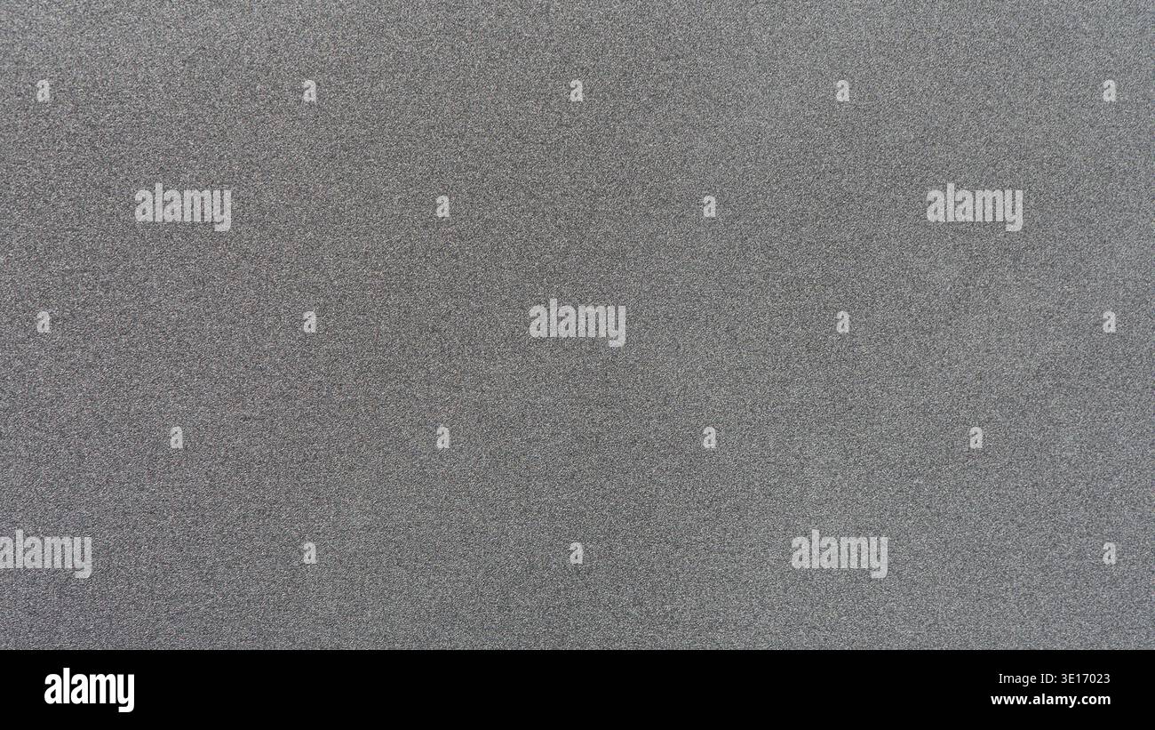 Grey gritty texture creating an abstract noise background surface Stock Photo