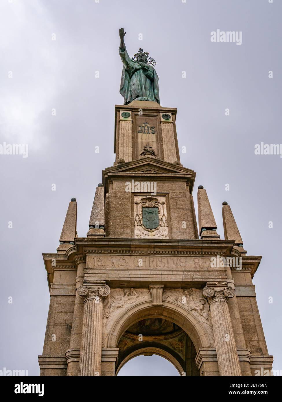 Towering bronze monument featuring a religious figure atop an ornate ...