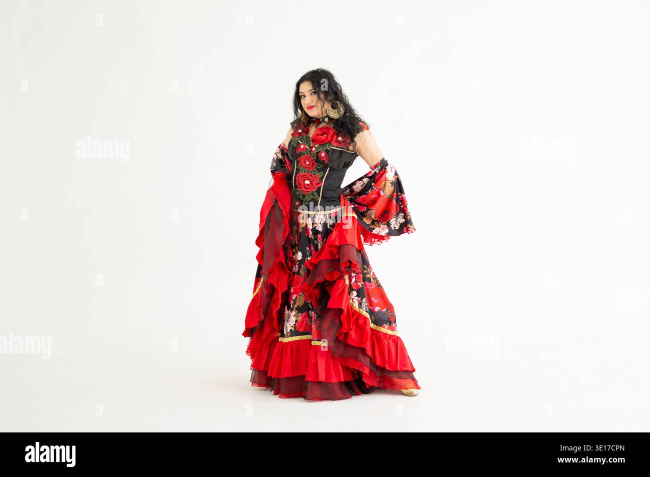 Beautiful Romani woman in traditional floral dress. Roma dancer posing in  vibrant gypsy style costume on white background. Elegant ethnic performer  in Stock Photo - Alamy
