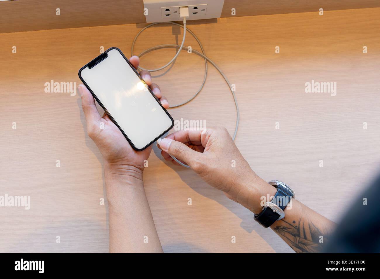 Smartphone charging,plugged into electrical outlet Stock Photo