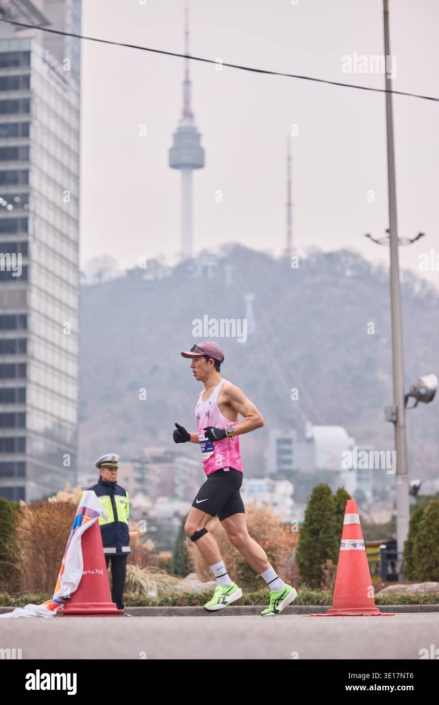 Seoul, South Korea: Male runner in pink singlet runs past N Seoul