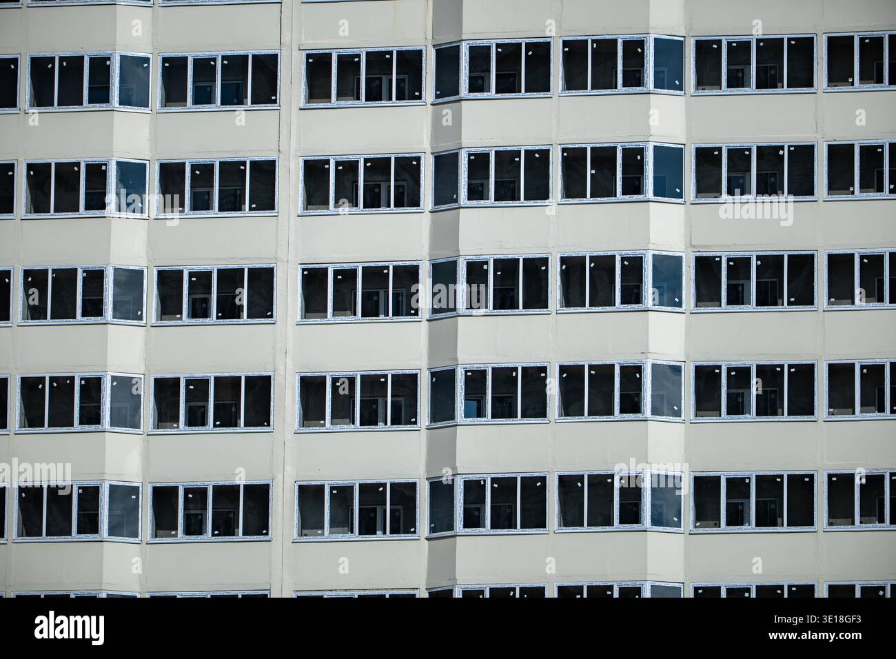 Building facade featuring many windows creating a modern architectural pattern Stock Photo