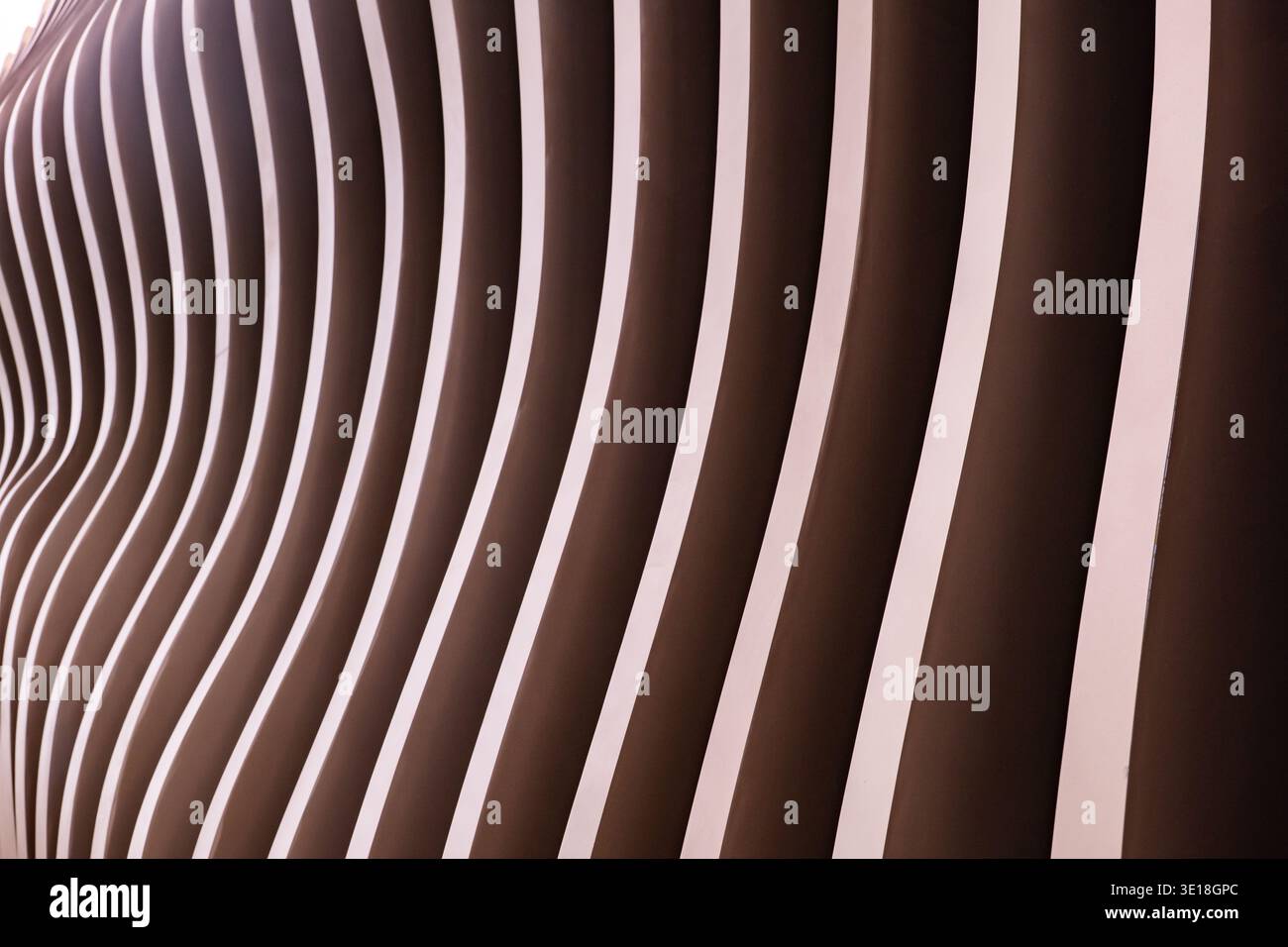 Modern wavy architectural facade showing parallel lines and rhythmic brown design Stock Photo