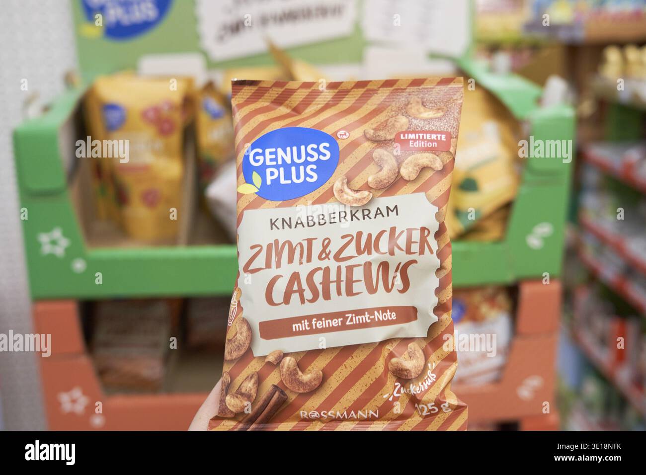 Packaging of cinnamon and sugar cashew nuts from the brand Genuss Plus on supermarket shelves, Genuss Plus, Rossmann, snack stuff Stock Photo