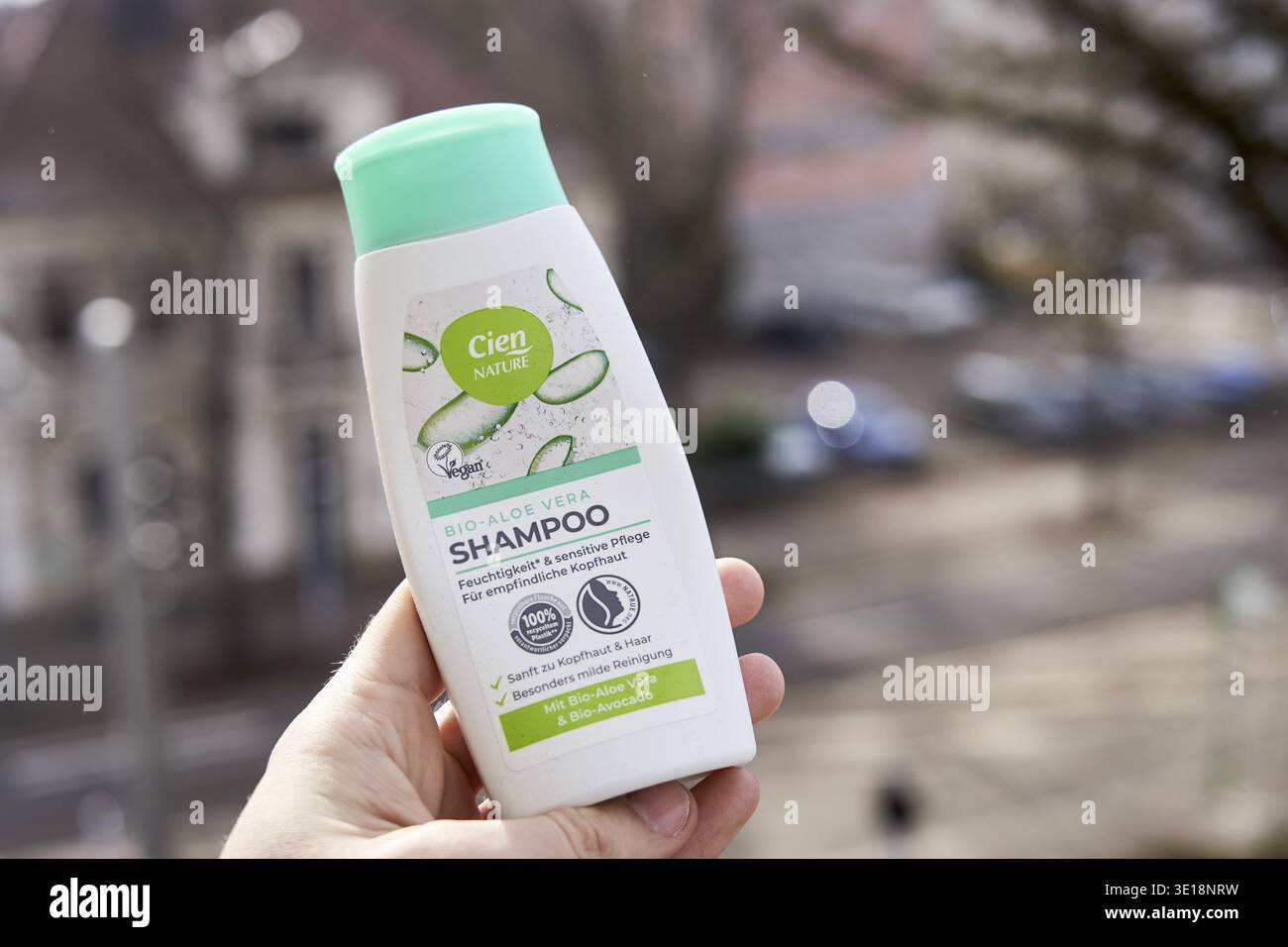 Cien Nature aloe vera shampoo bottle held by one hand, natural moisturizer  accentuates natural cosmetics Stock Photo - Alamy