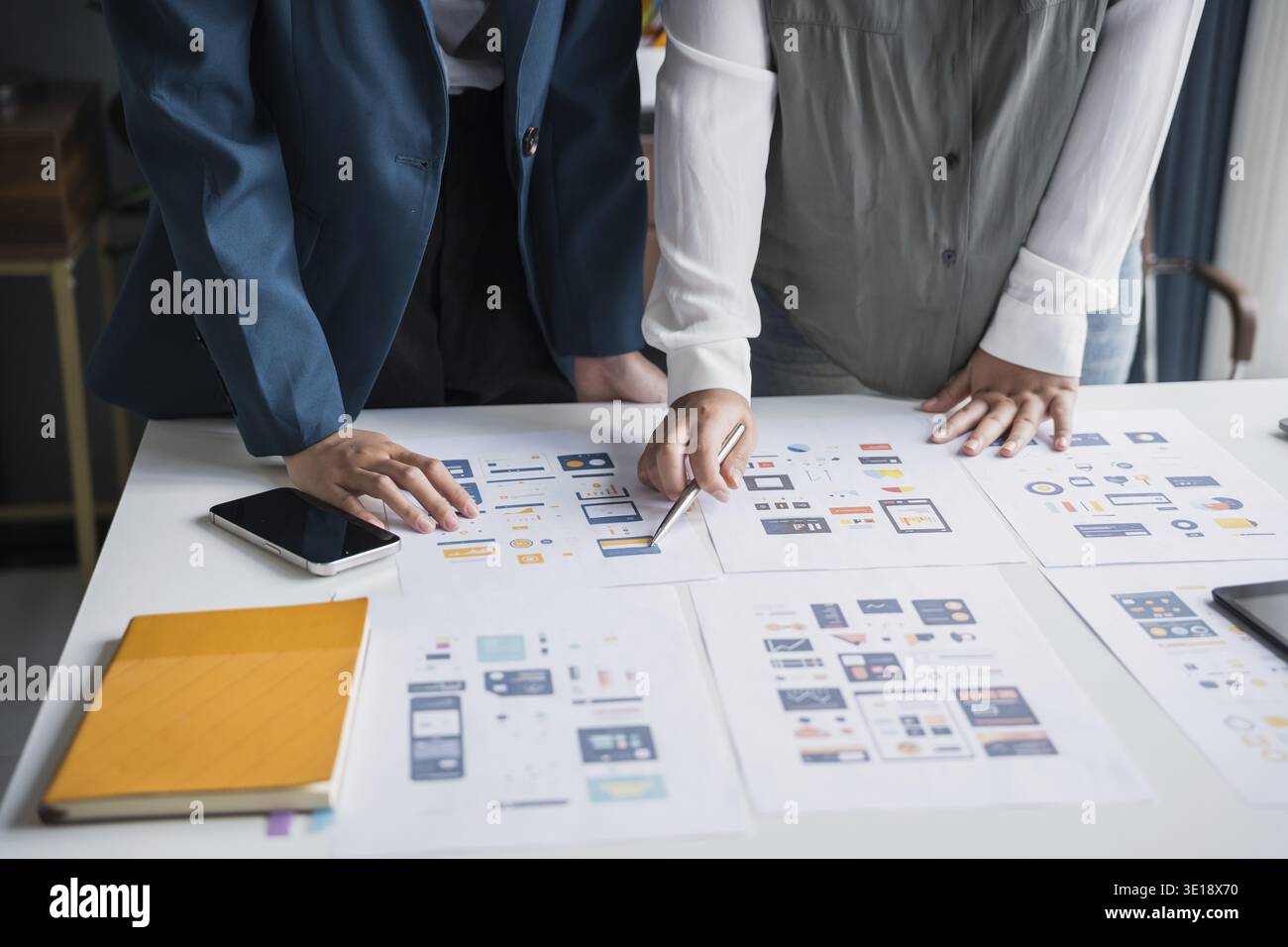 Developer team brainstorming user interface and experience designs for mobile application ux ui graphic prototype Stock Photo