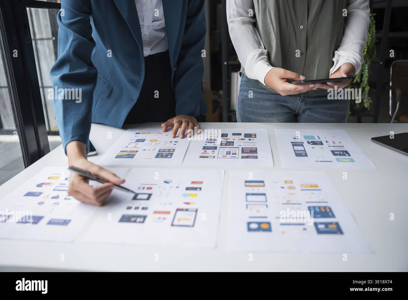 Developer team brainstorming user interface and experience designs for mobile application ux ui graphic prototype Stock Photo