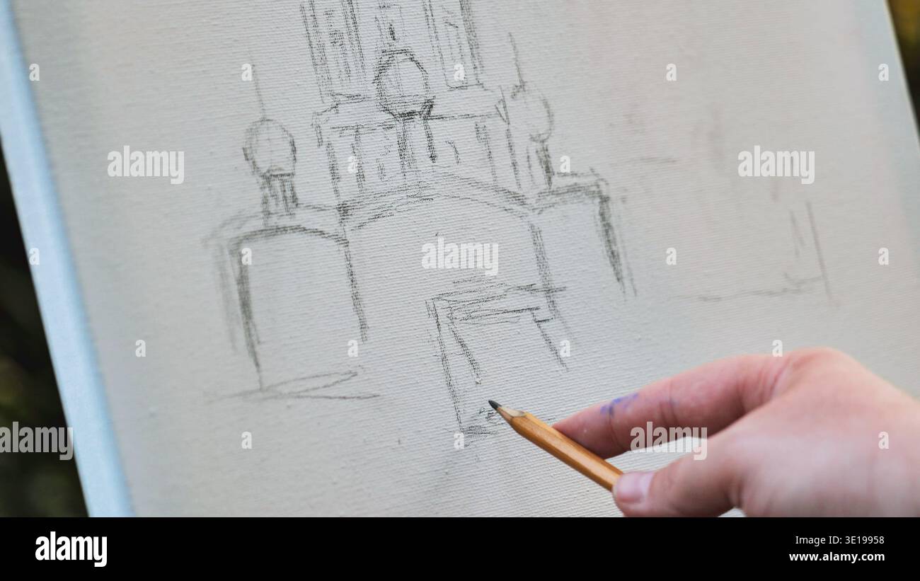 Artist sketching building on canvas using pencil Stock Photo