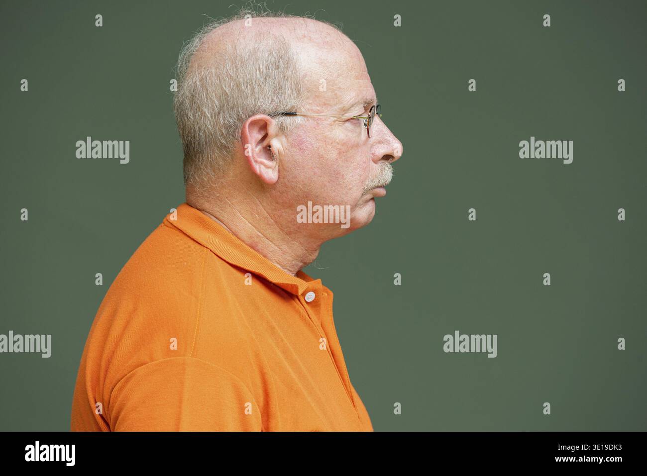 Profile view of grey haired senior man with mustache wearing eyeglasses horizontal shot Stock Photo