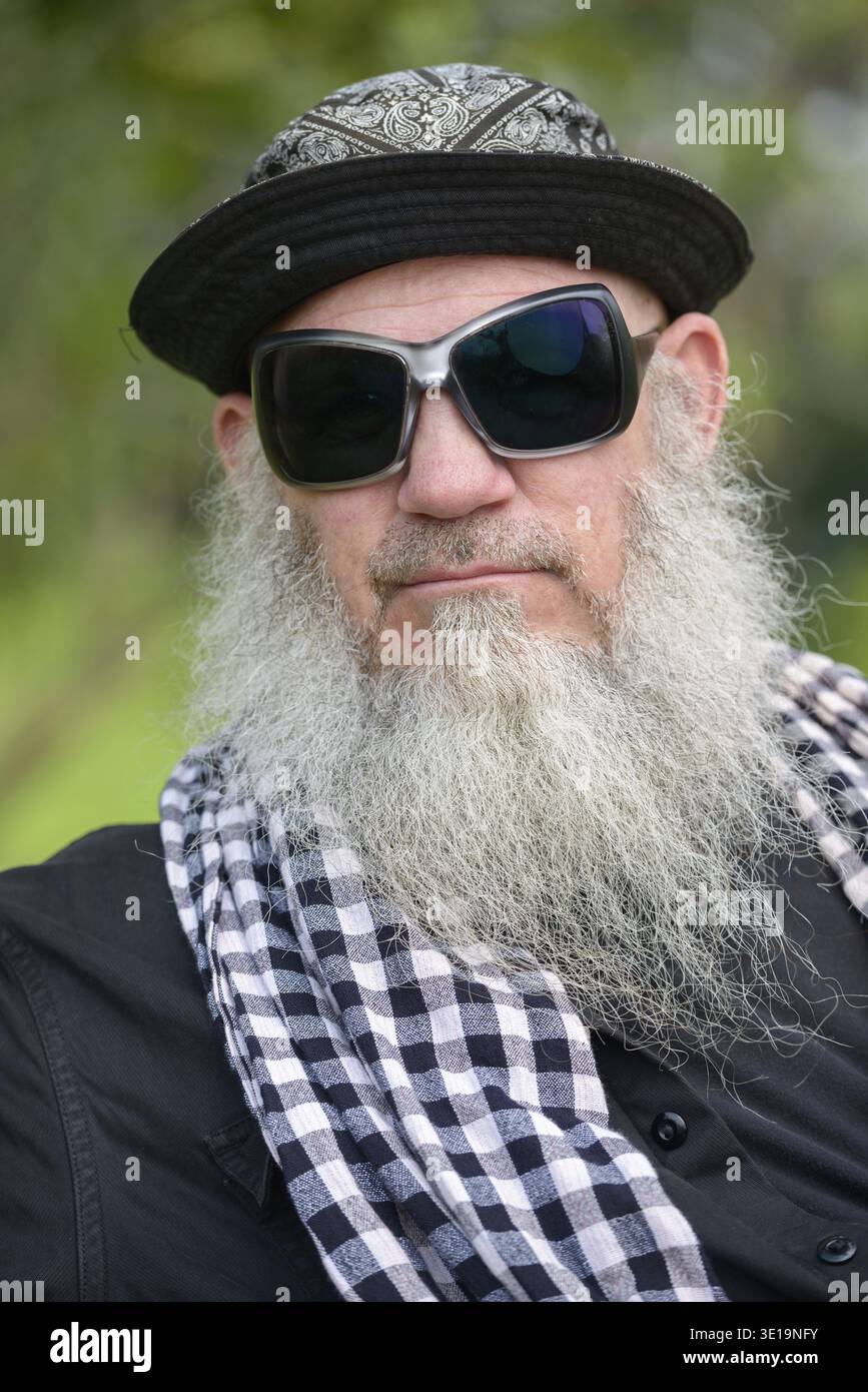 Portrait of mature bearded hipster man at the park outdoors Stock Photo
