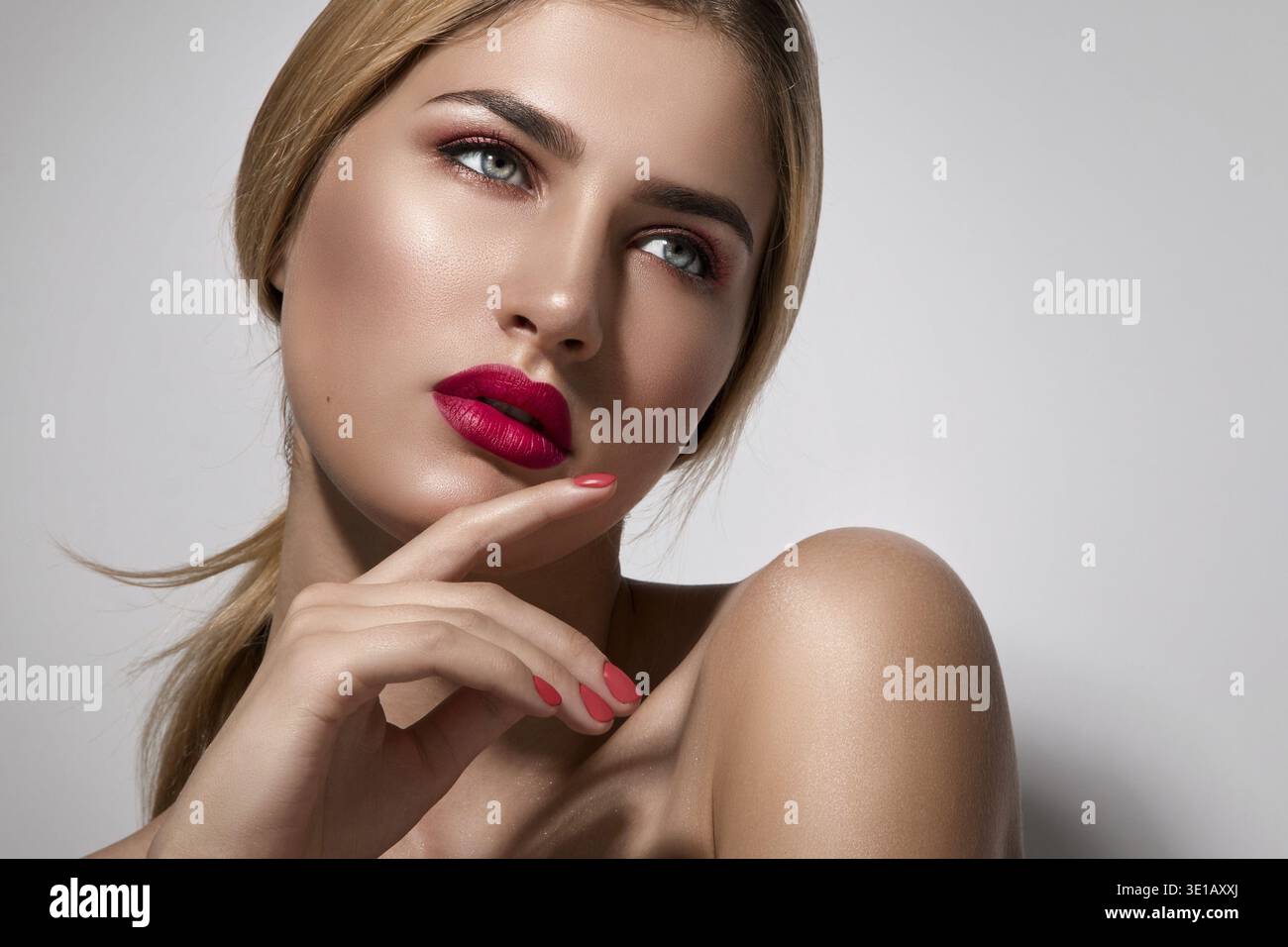 Beautiful blonde woman with red lips posing in studio Stock Photo