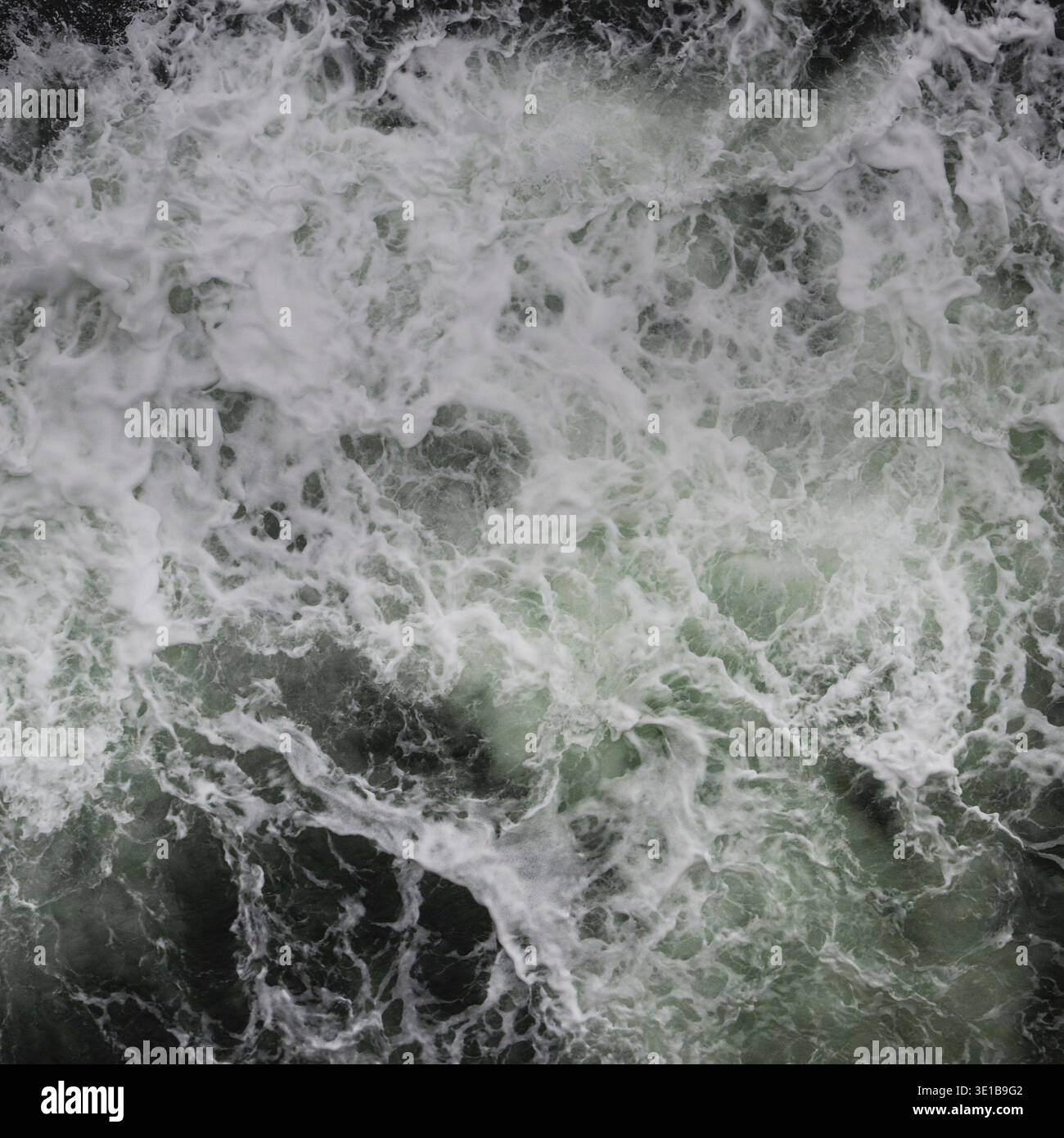 Big water splash seen from above a boat Stock Photo