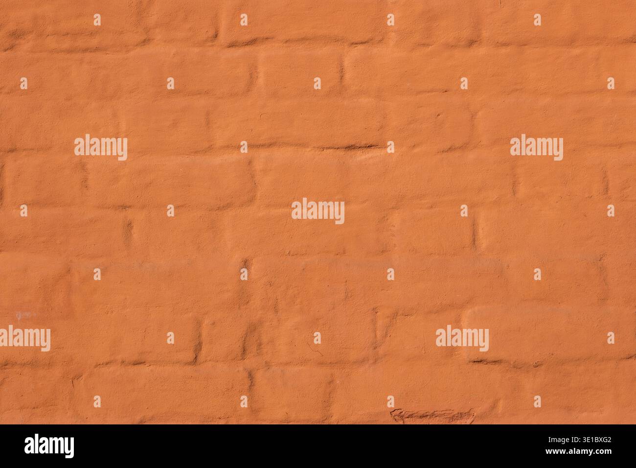 Orange painted brick wall texture with rough surface for backgrounds Stock Photo