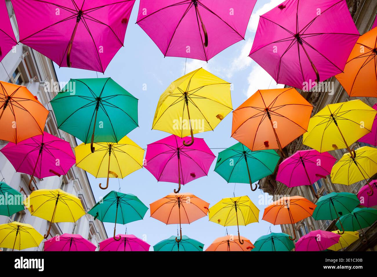 Multicolored umbrellas against a blue sky Stock Photo