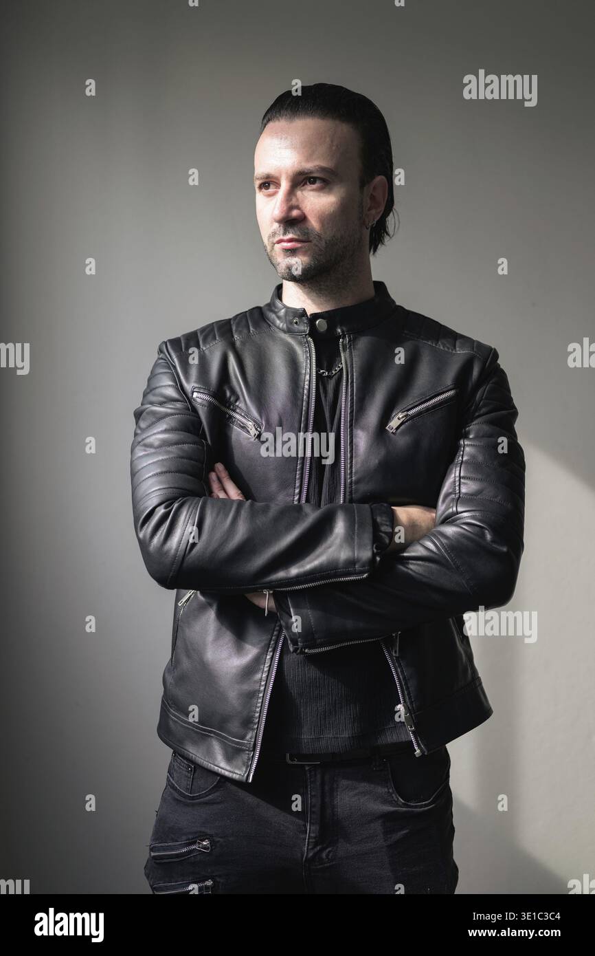 Confident bearded man wearing black leather jacket Stock Photo