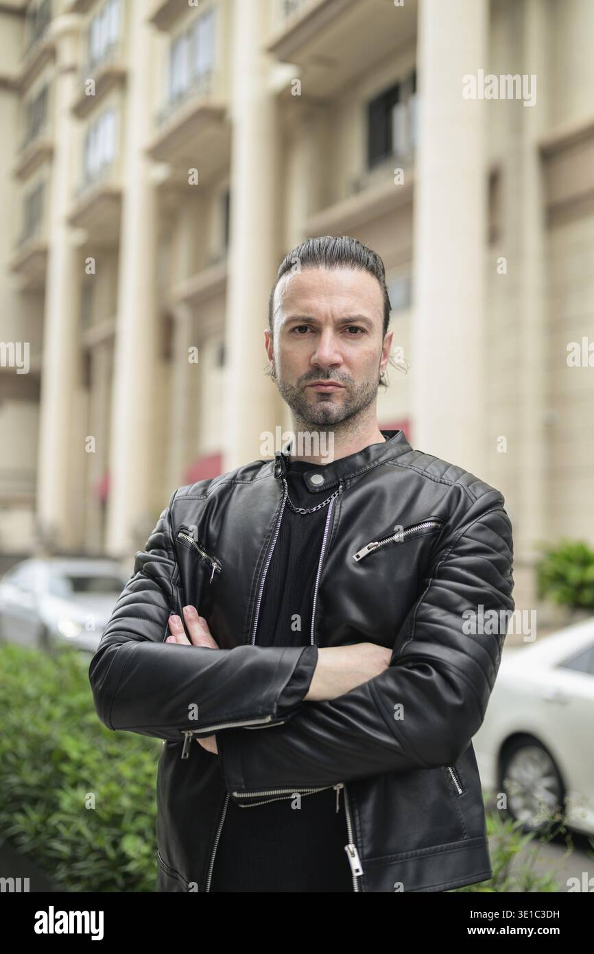 Confident bearded man wearing black leather jacket Stock Photo