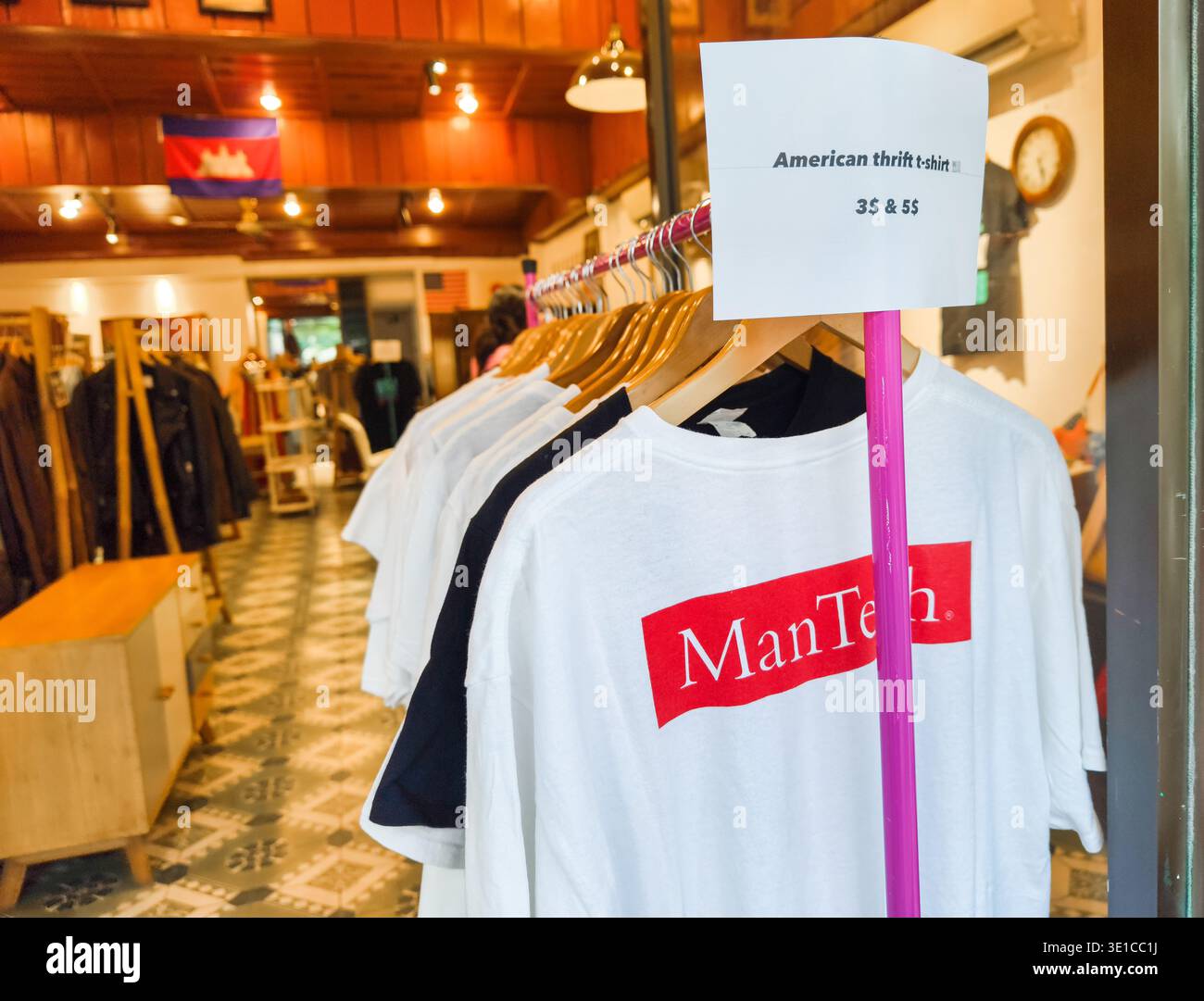 retail rack featuring American vintage or thrifted T-shirts, with price tag in USD, sold in Phnom Penh, Cambodia boutique Stock Photo